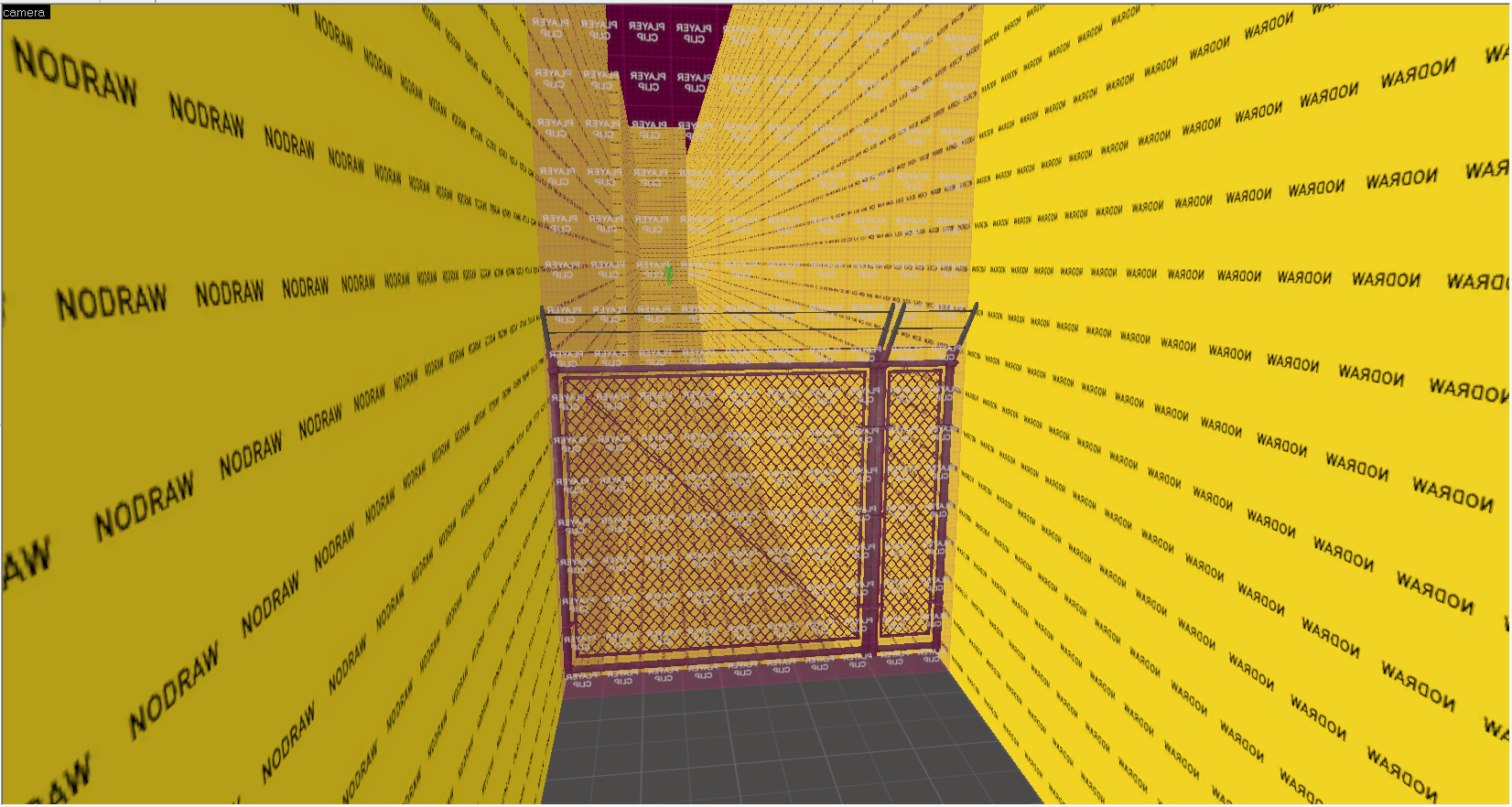 A Screenshot of Source Hammer Editor displaying an alleyway with a chainlink fense and development meshes