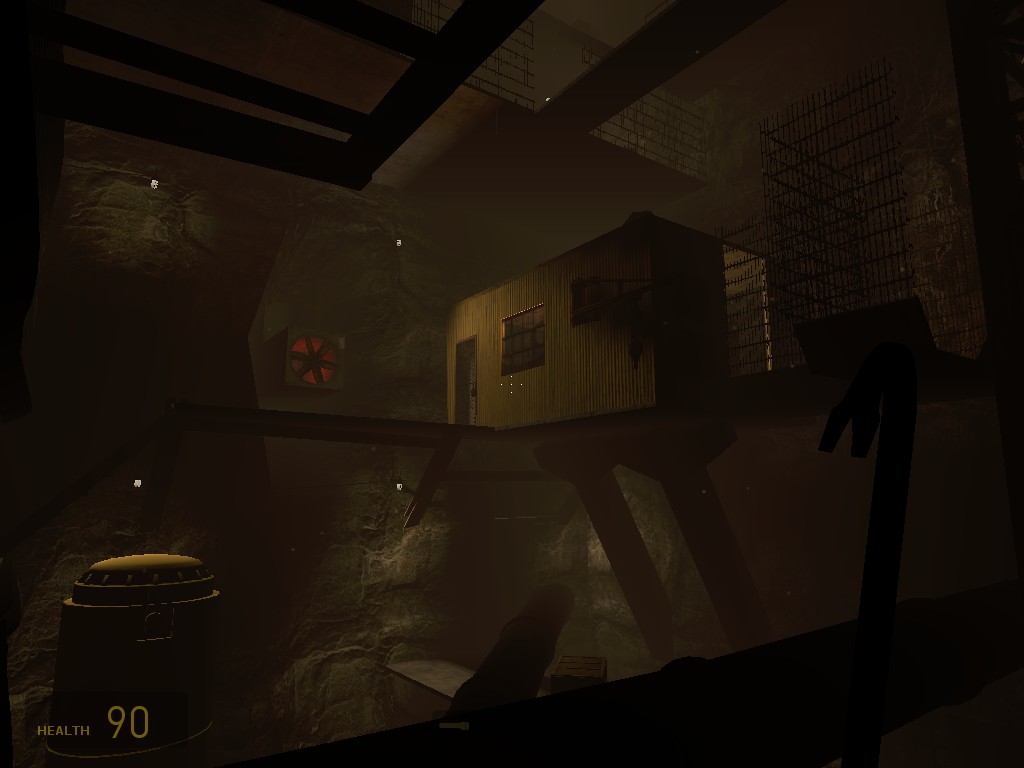 A Source Engine screenshot displaying a small office built into a mineshaft with sheet metal