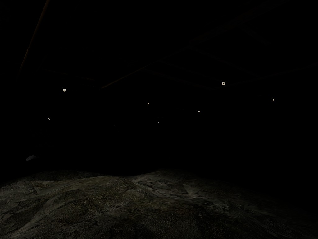 A Source Engine screenshot displaying a nearly black mine barely lit with cage lights illuminating stone