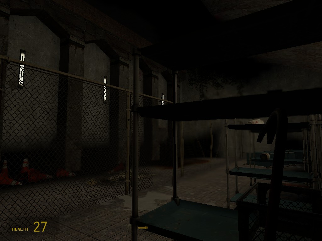 A Source Engine screenshot displaying a concrete storage space with shelves of junk and a gas leak